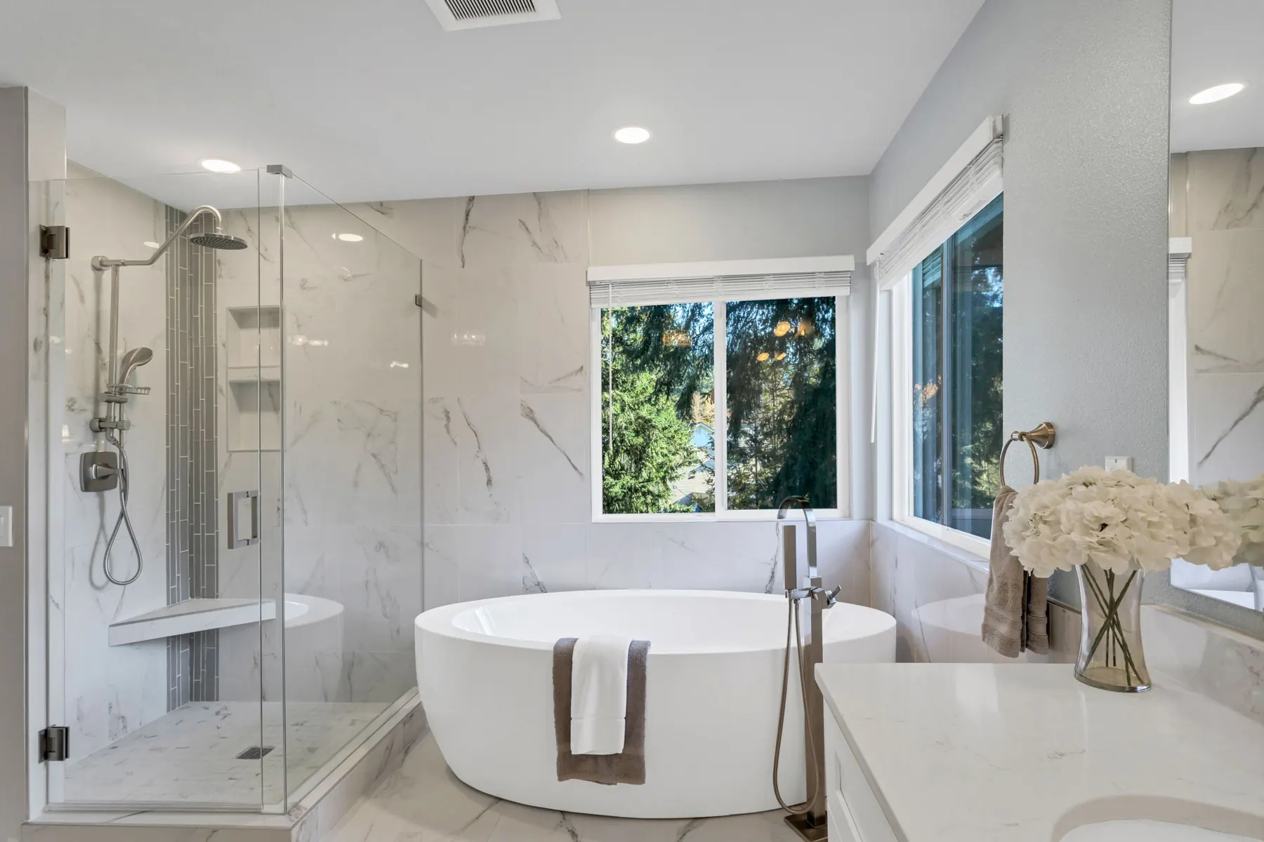 Modern bathroom with a freestanding bath by a window